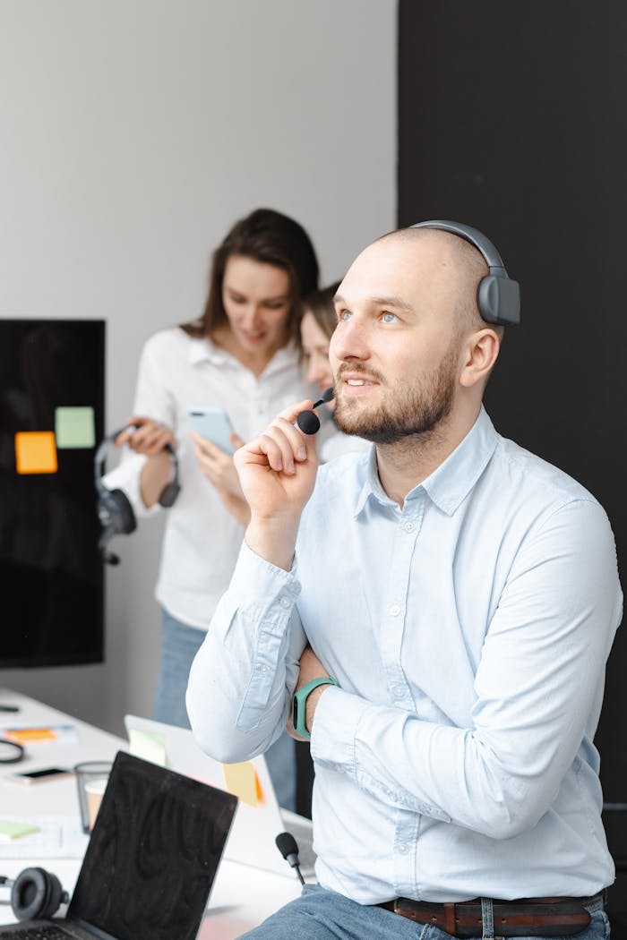 Man with headset working in a modern office, representing customer support services.